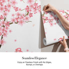 Pink flamingos beneath falling cherry blossoms with tropical plants against light gray background - view 3 - final